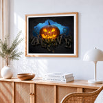 Glowing jack o lantern and halloween typography cross stitch artwork displayed on wall as home decor