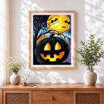 Finished glowing jack-o'-lantern in a starry night cross stitch artwork displayed