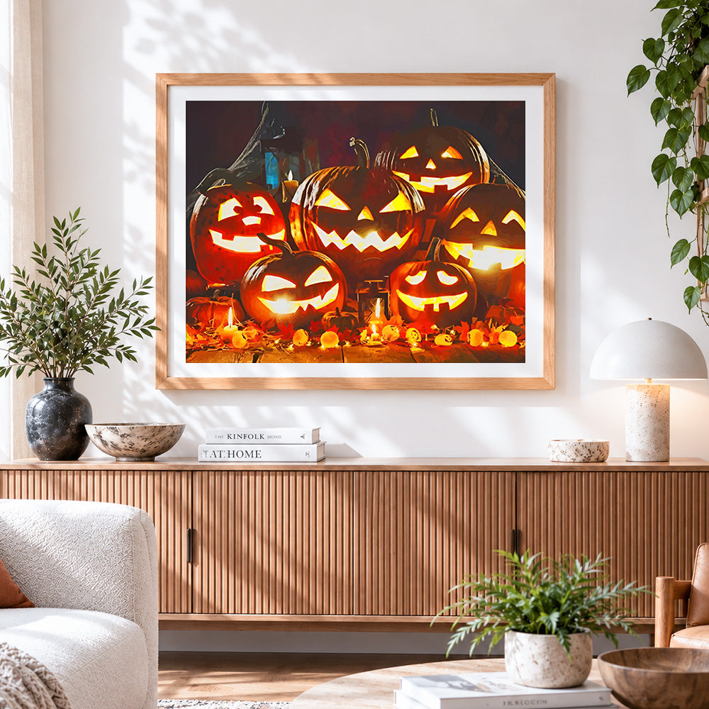 Finished glowing jack-o'-lanterns and candles cross stitch artwork displayed