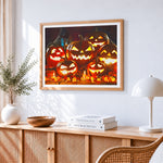 Glowing jack-o'-lanterns and candles cross stitch artwork displayed on wall as home decor
