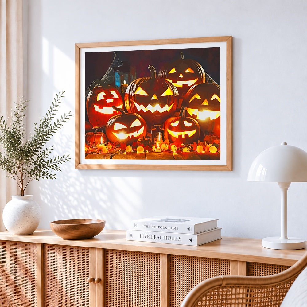 Glowing jack-o'-lanterns and candles cross stitch artwork displayed on wall as home decor