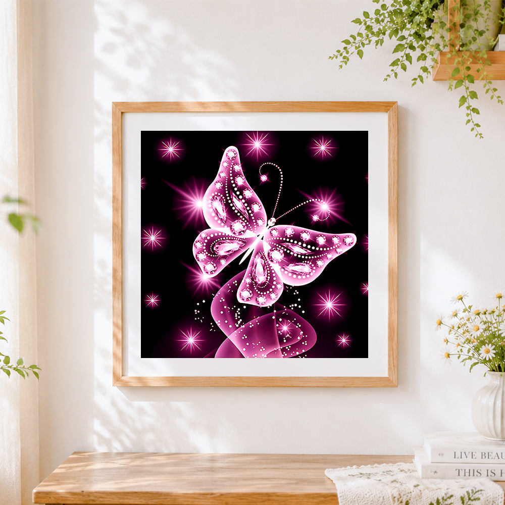 Finished glowing pink crystal butterfly cross stitch artwork displayed