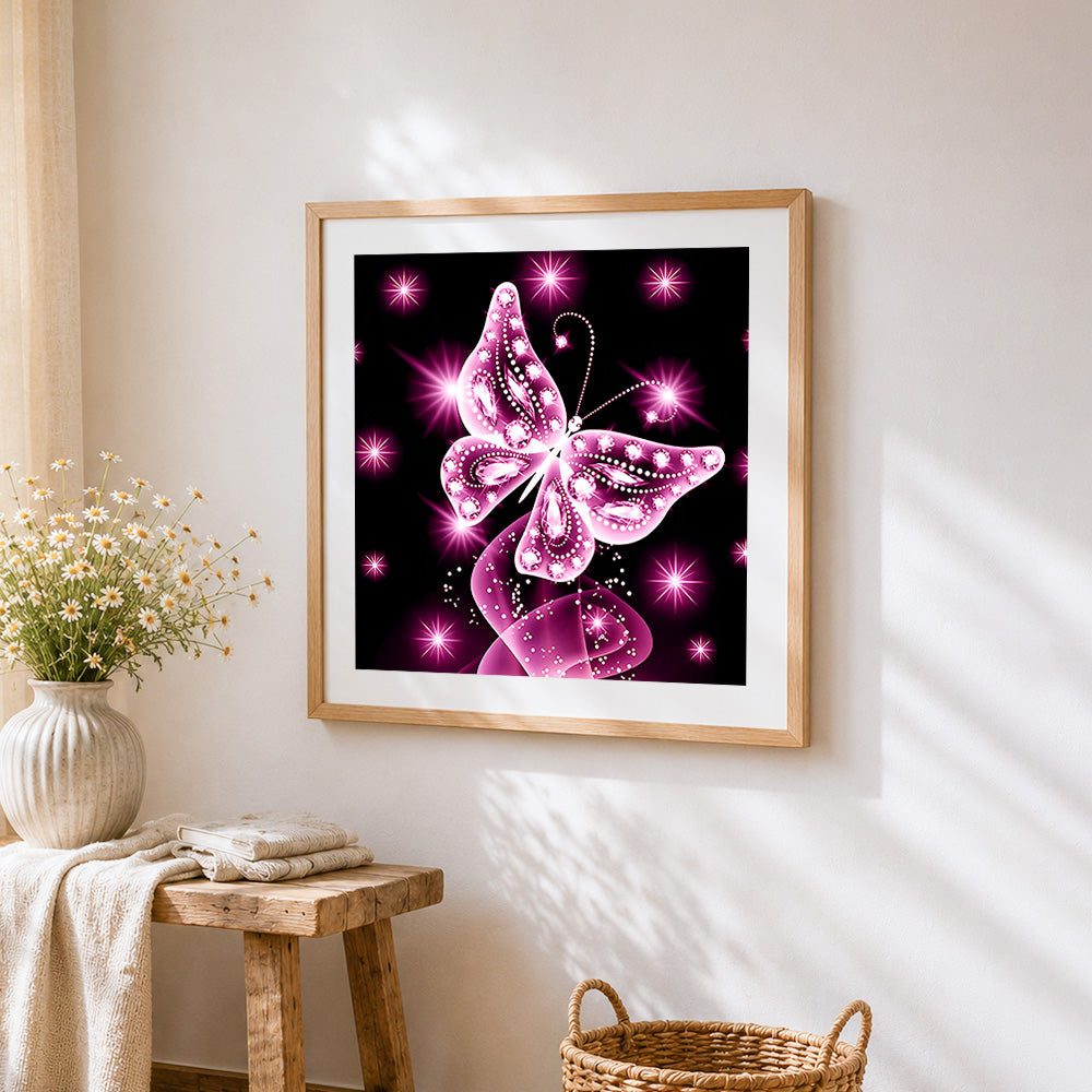 Glowing pink crystal butterfly cross stitch artwork displayed on wall as home decor
