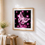 Glowing pink crystal butterfly cross stitch artwork displayed on wall as home decor