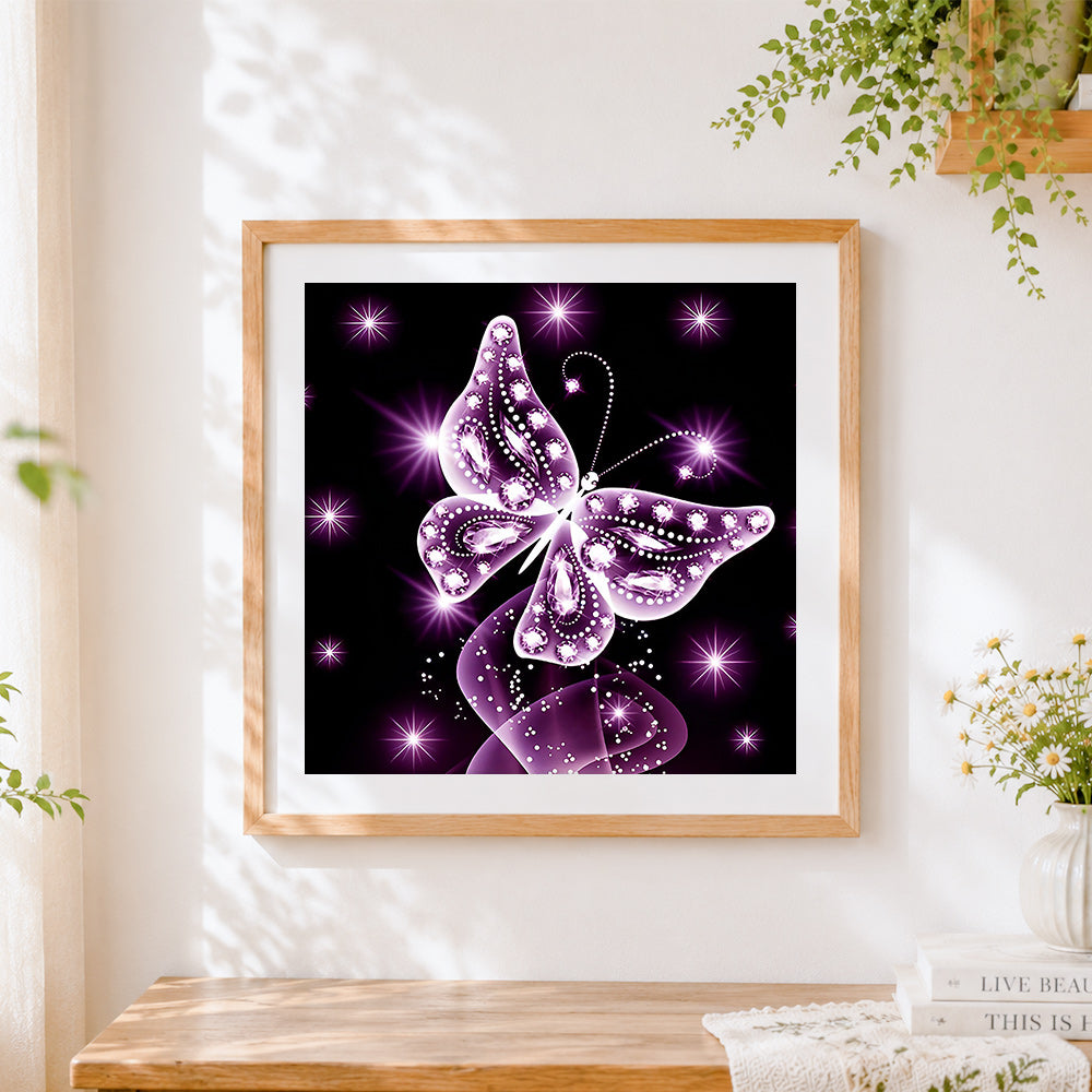 Finished glowing purple crystal butterfly cross stitch artwork displayed