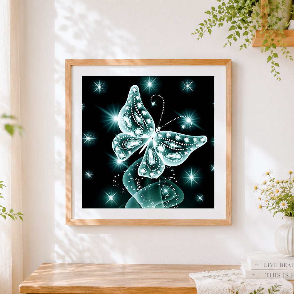 Finished glowing teal crystal butterfly cross stitch artwork displayed