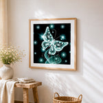 Glowing teal crystal butterfly cross stitch artwork displayed on wall as home decor