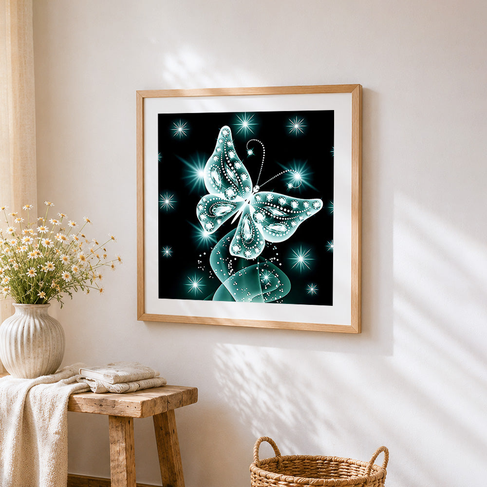 Glowing teal crystal butterfly cross stitch artwork displayed on wall as home decor