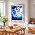 Glowing tiger in water cross stitch artwork displayed on wall as home decor