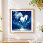 Finished glowing white unicorn cross stitch artwork displayed