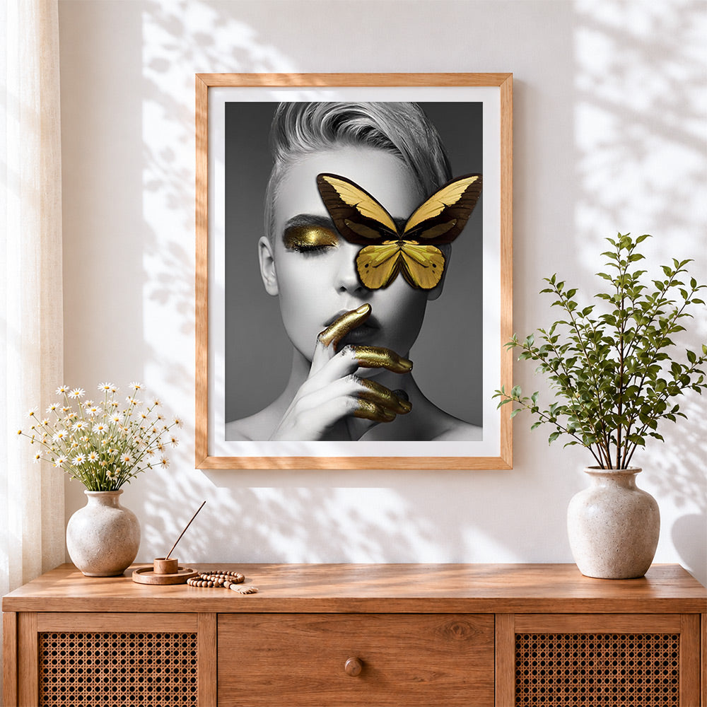 Finished gold butterfly blindfold portrait cross stitch artwork displayed