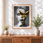 Finished gold butterfly blindfold portrait cross stitch artwork displayed