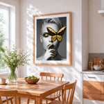 Gold butterfly blindfold portrait cross stitch artwork displayed on wall as home decor