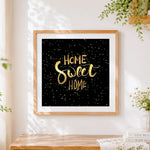 Finished gold home sweet home on black starry background cross stitch artwork displayed