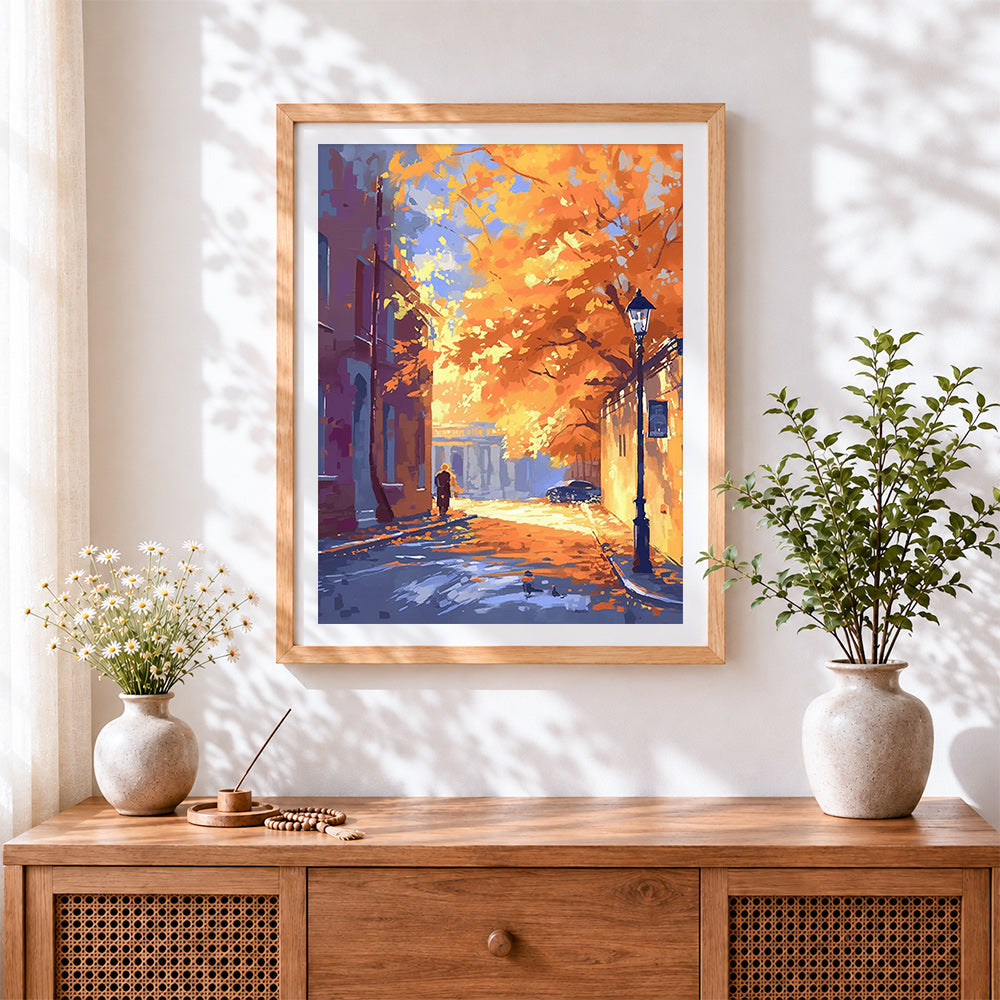 Finished golden autumn street scene cross stitch artwork displayed