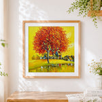 Finished golden autumn tree and lakeside village cross stitch artwork displayed