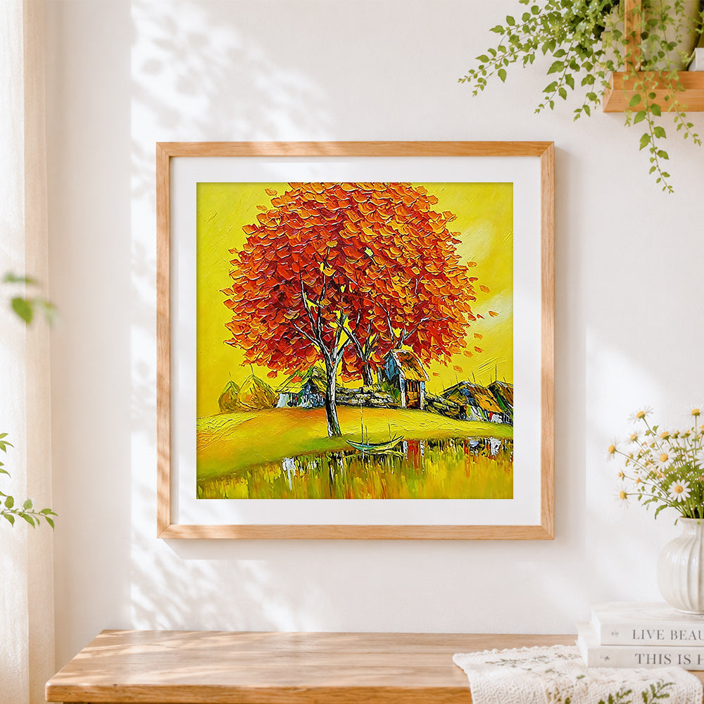 Finished golden autumn tree and lakeside village cross stitch artwork displayed
