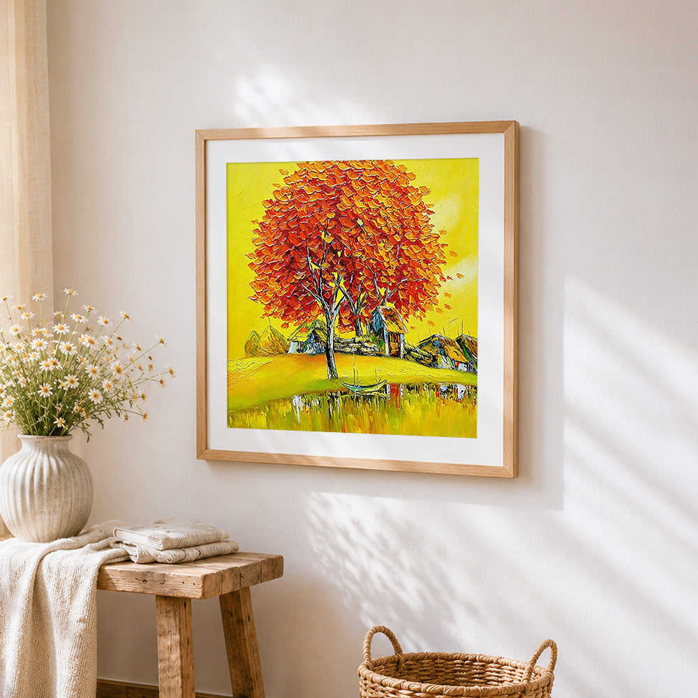 Golden autumn tree and lakeside village cross stitch artwork displayed on wall as home decor