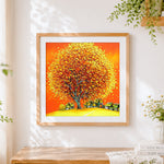 Finished golden autumn tree and village cross stitch artwork displayed