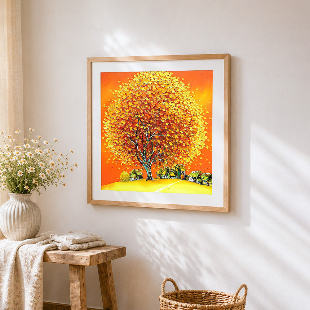 Golden autumn tree and village cross stitch artwork displayed on wall as home decor