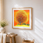 Golden autumn tree and village cross stitch artwork displayed on wall as home decor