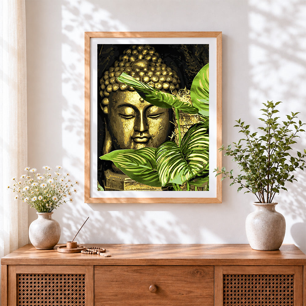 Finished golden buddha with botanical leaves cross stitch artwork displayed