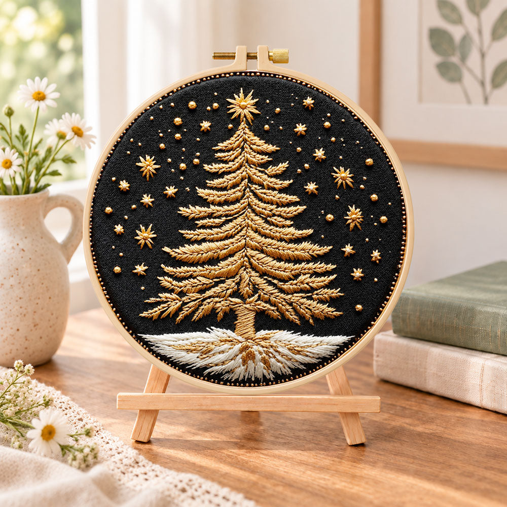 Golden festive tree embroidery kit finished hoop displayed on a wooden stand as cosy tabletop decor