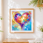 Finished golden heart with colourful collage cross stitch artwork displayed