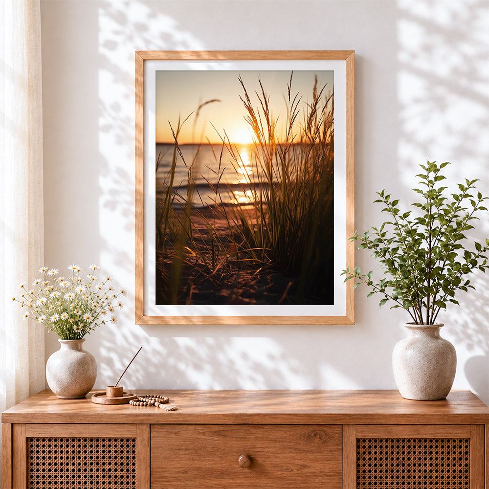 Finished golden hour beach grass silhouette cross stitch artwork displayed