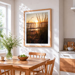 Golden hour beach grass silhouette cross stitch artwork displayed on wall as home decor