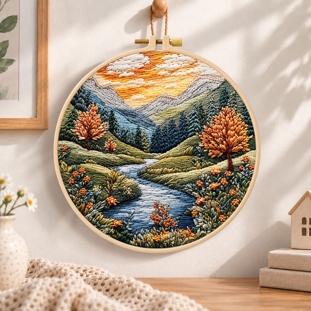Golden hour mountain river embroidery hoop wall art displayed as warm and cozy handmade home decor