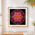 Finished golden orange and purple ornate mandala cross stitch artwork displayed