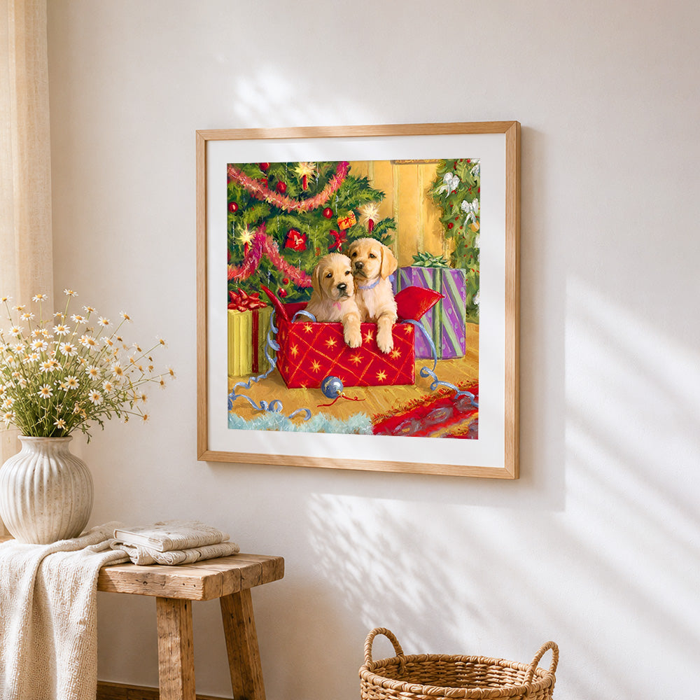 Golden retriever puppies in a christmas box cross stitch artwork displayed on wall as home decor