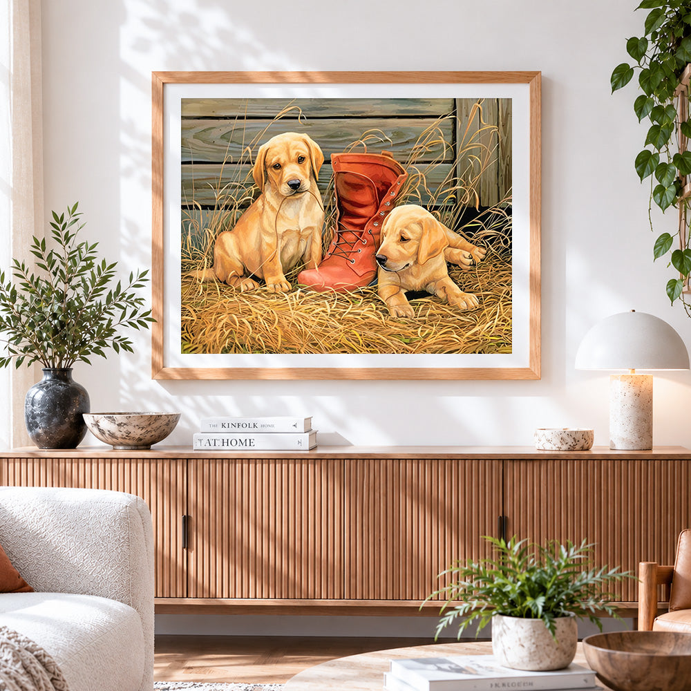 Finished golden retriever puppies with red boot cross stitch artwork displayed