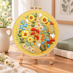 Golden sunflower wreath with white birds embroidery kit finished hoop displayed on a wooden stand as cosy tabletop decor