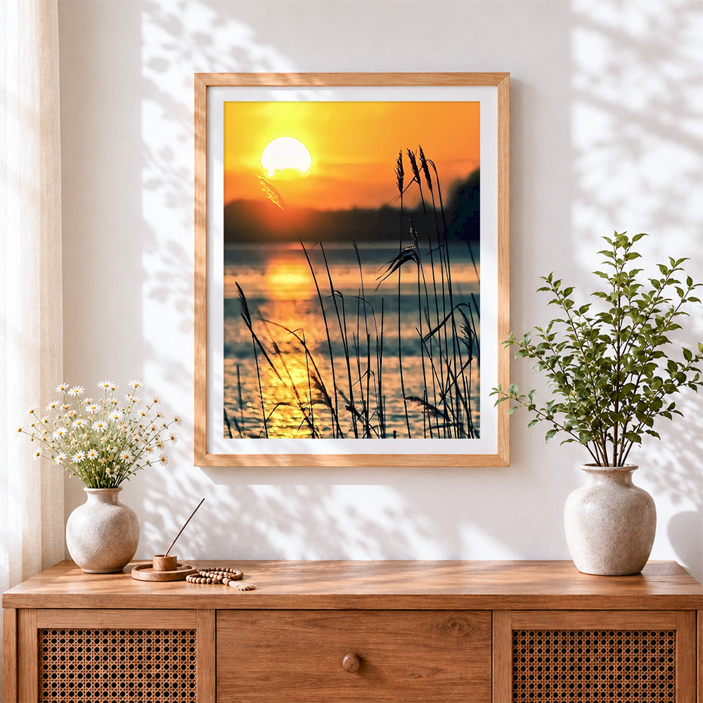 Finished golden sunset reeds silhouette cross stitch artwork displayed