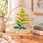 Goldenrod sprig embroidery kit finished hoop displayed on a wooden stand as cozy tabletop decor