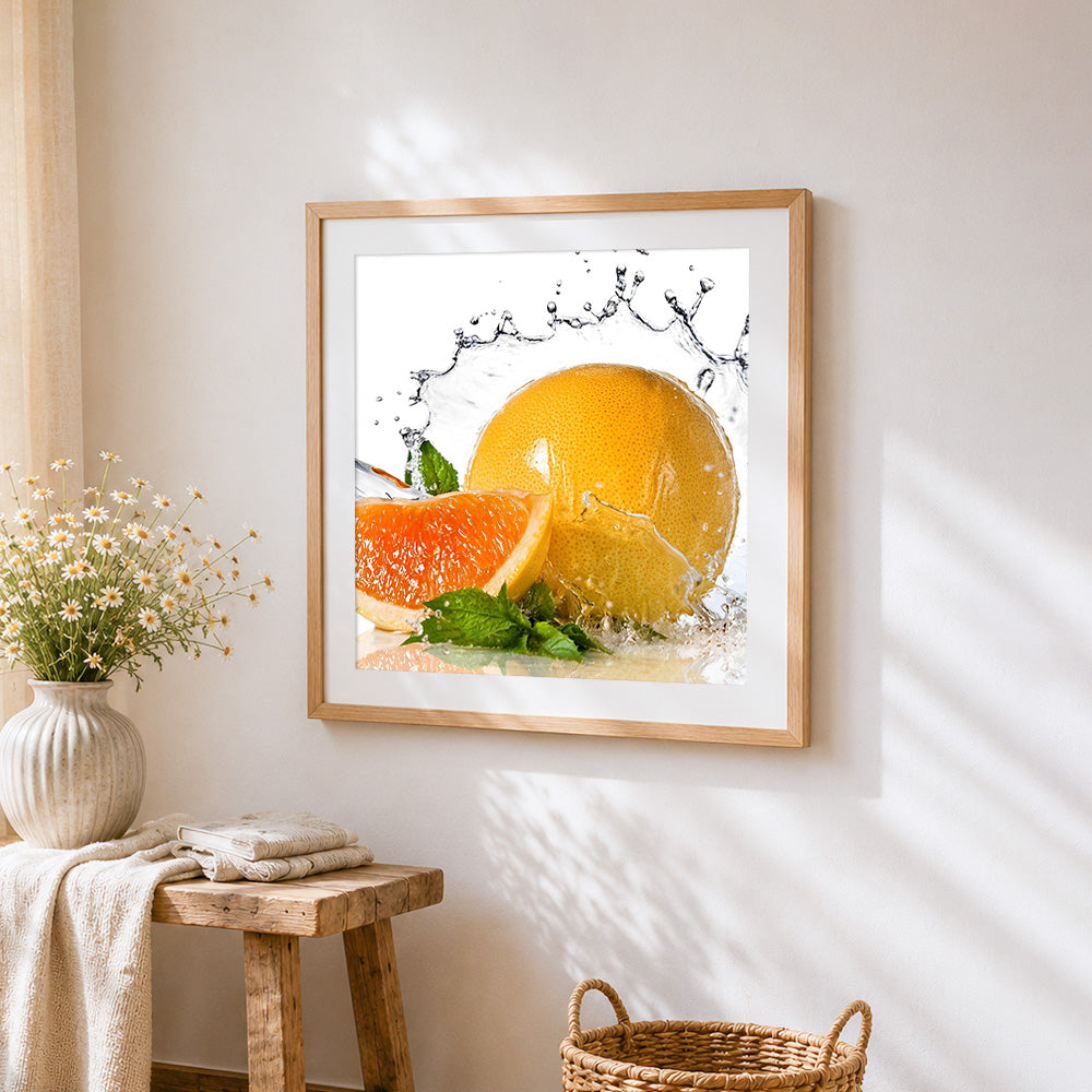 Grapefruit and water splash cross stitch artwork displayed on wall as home decor