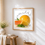 Grapefruit and water splash cross stitch artwork displayed on wall as home decor