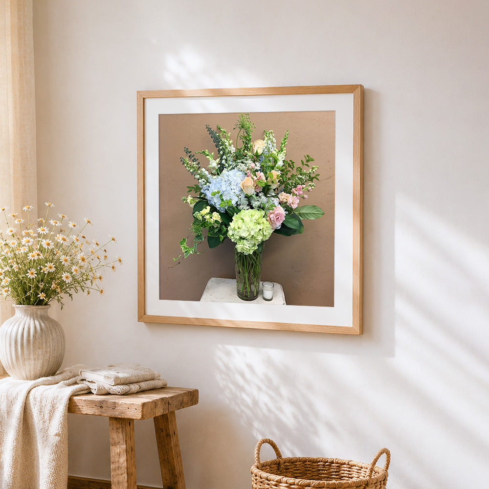 Green and blue hydrangea arrangement cross stitch artwork displayed on wall as home decor