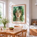 Green eyed nature goddess cross stitch artwork displayed on wall as home decor