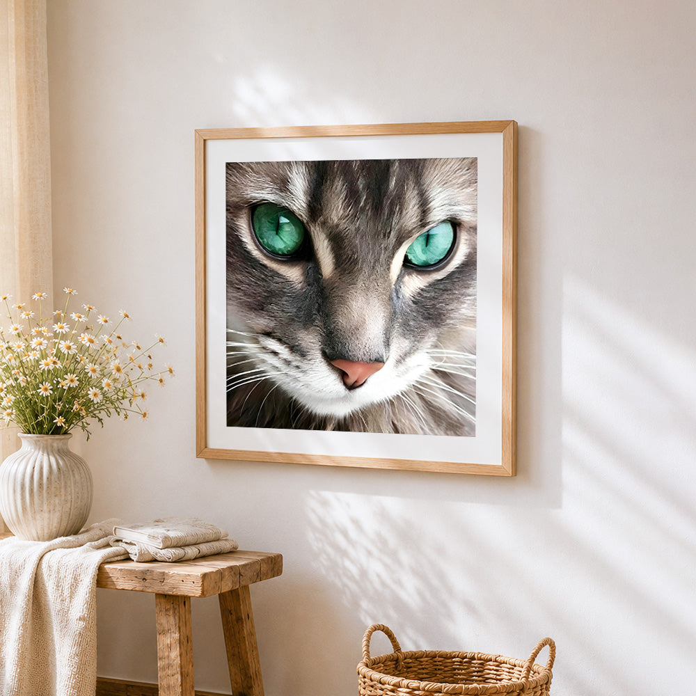 Green eyed tabby cat cross stitch artwork displayed on wall as home decor