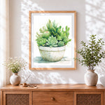 Finished green potted succulents cross stitch artwork displayed