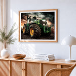 Green tractor in stormy field cross stitch artwork displayed on wall as home decor