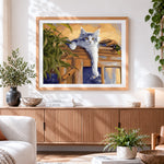 Finished grey cat lounging on a cabinet cross stitch artwork displayed
