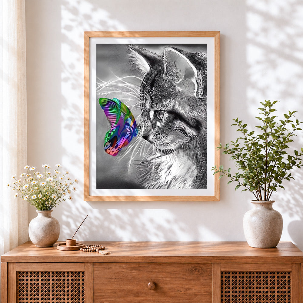Finished grey cat with a colourful butterfly cross stitch artwork displayed