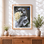 Finished grey cat with a white rose cross stitch artwork displayed