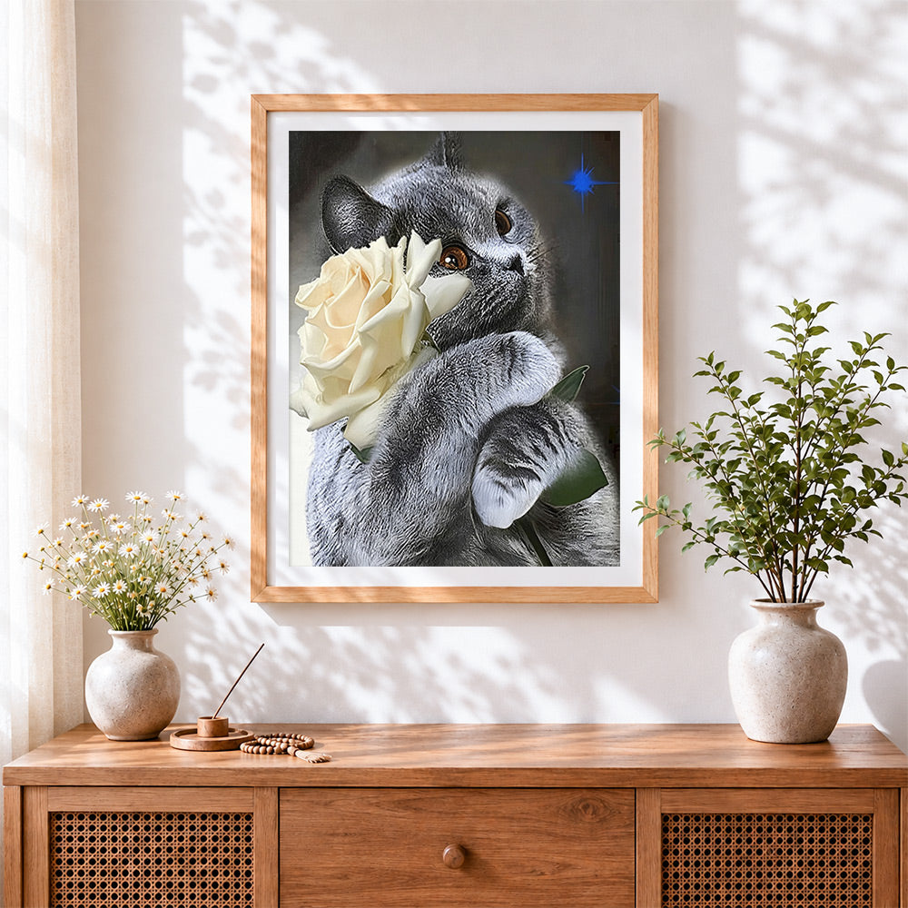 Finished grey cat with a white rose cross stitch artwork displayed