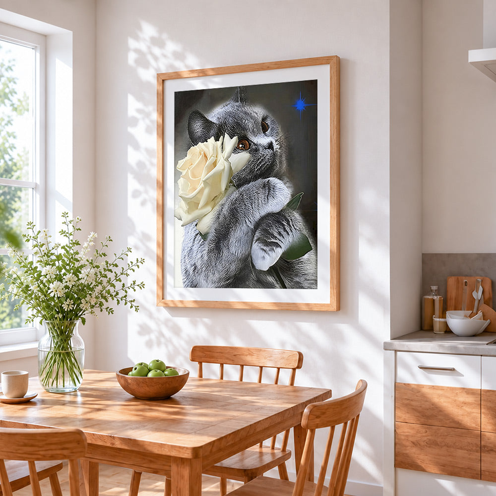 Grey cat with a white rose cross stitch artwork displayed on wall as home decor