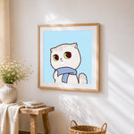 Grey cat with blue scarf cross stitch artwork displayed on wall as home decor